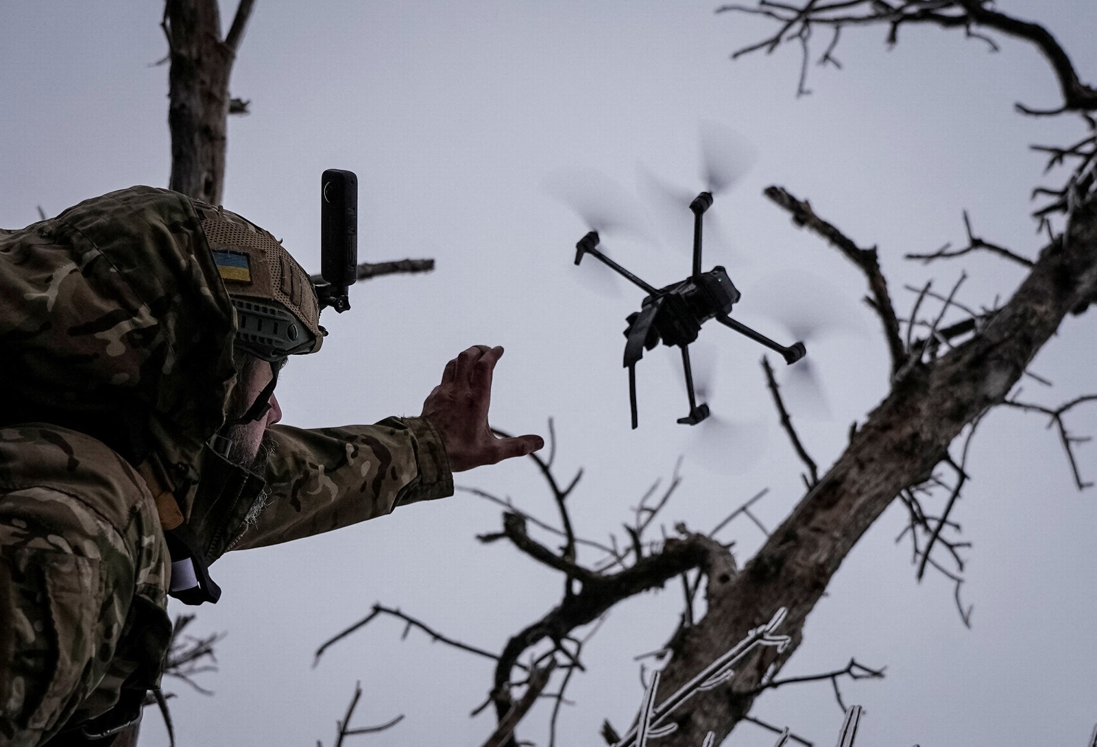 A Ukrainian soldier deploying an FPV drone during combat operations