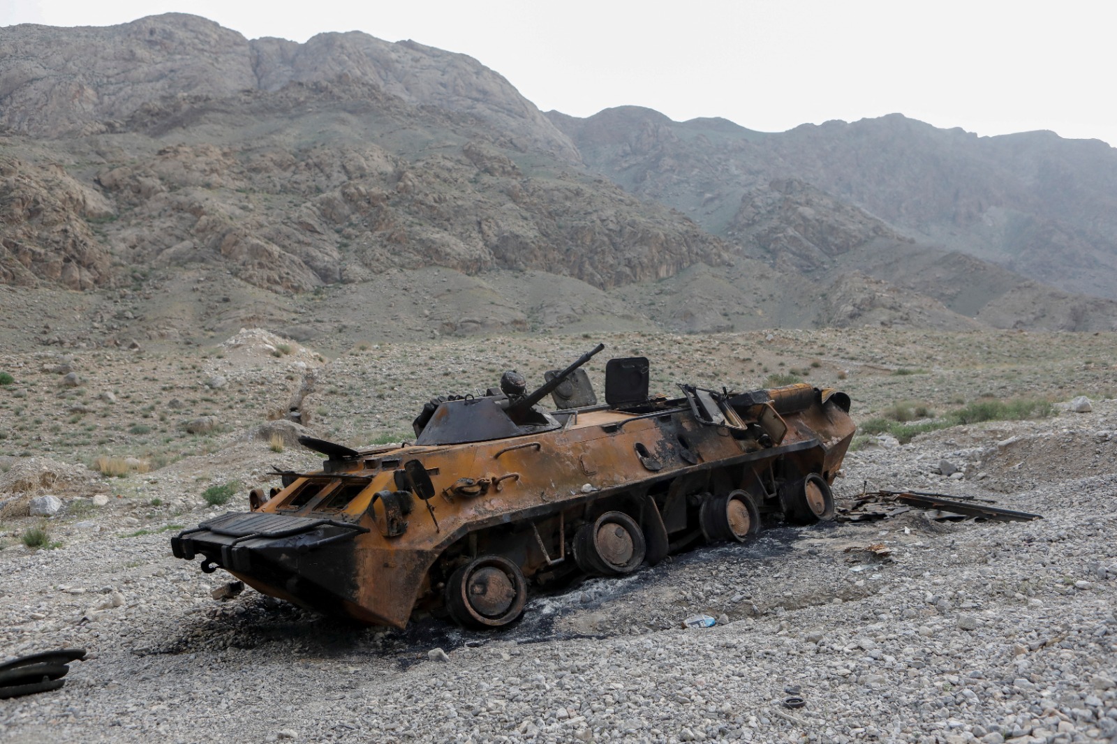 Destroyed armoured vehicle from the 2021 Kyrgyzstan-Tajikistan border clash in a mountainous landscape